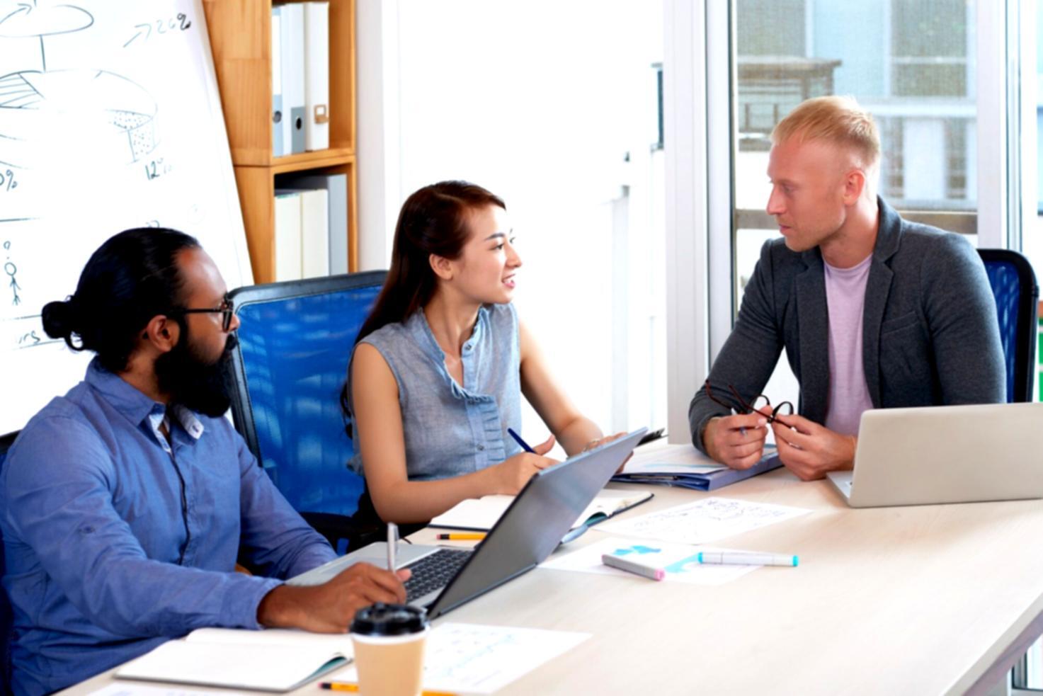 Business professionals analyzing financial reports with calculators